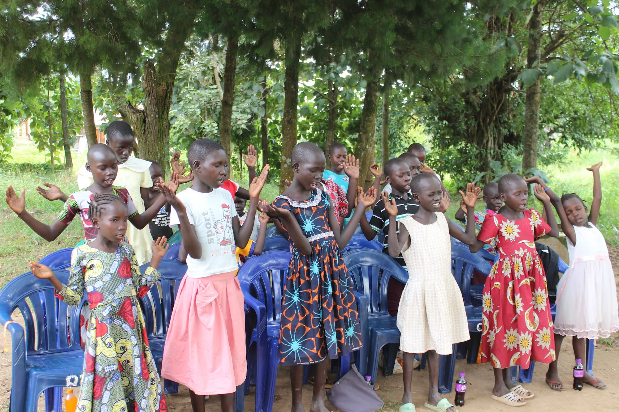 Sponsored children singing together at program day